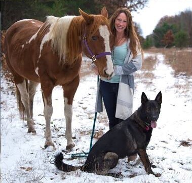 Dr. Amanda with horse and dog in snow